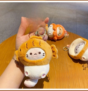 Cute plush cat keychain with orange snack headwear and golden metal ring detail