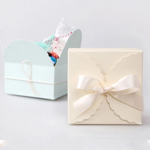 Minimalist square folding gift boxes in beige with ribbon and light blue open style