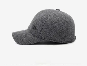 Detailed side view of dark grey winter baseball cap showing thick tweed fabric texture