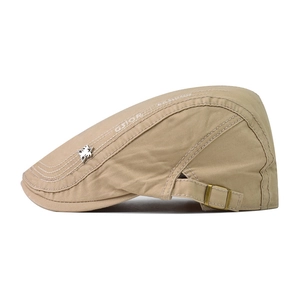 Detail view of khaki ivy cap with star metal badge and adjustable metal buckle