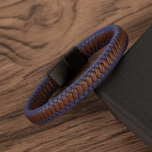 Detail of brown and blue braided leather men's bracelet with black magnetic clasp