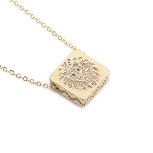 Golden lion head pendant necklace with sparkling micro-pave zircons and green stone eyes