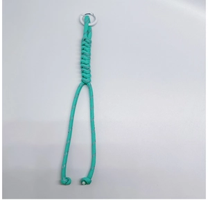 Detail view of handmade mint green braided paracord lanyard with white metal spring clip