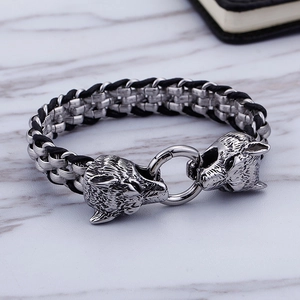 Detail of stainless steel wolf head clasp and black braided leather on men's bracelet
