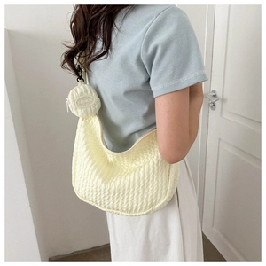 Detail of light yellow seersucker crossbody bag featuring a round FASHION coin purse