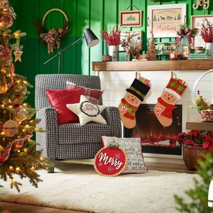 Close-up of gingerbread man Christmas stockings with plaid cuffs hanging on a fireplace