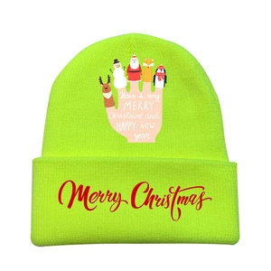 Detail of neon green knitted hat with festive hand graphic and Merry Christmas text
