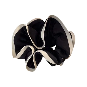 Elegant French style black and white satin scrunchie with soft pleated texture