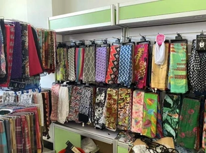 Assorted jacquard pashmina scarves with diverse patterns on retail store display racks