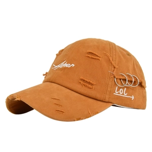 Detail of distressed baseball cap with Asher embroidery and silver metal rings