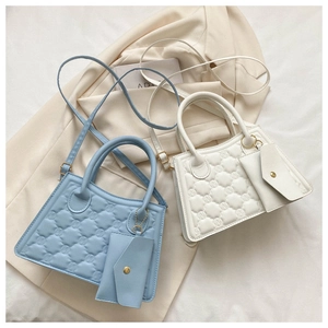 Detail of blue and white quilted crossbody bags with detachable small coin purses