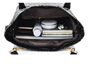 Macro shot of snakeskin tote bag interior showing large capacity for tablet and cosmetics