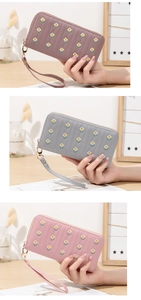 Detailed close-up of floral embroidery on PU leather long wallets in three pastel colors