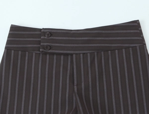 Detail of high-waisted charcoal pinstripe trousers featuring a double button closure