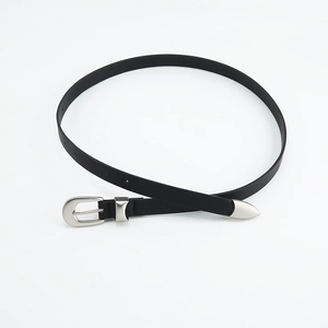 Detail of slim black leather belt with silver oval buckle and metal tip on white background