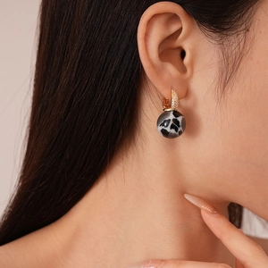 Vintage gold hoop earrings with black and white resin orb and sparkling zircon stones
