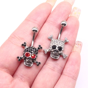 Skull belly button ring set in silver and black metal with sparkling crystal accents