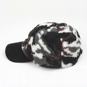 Detail of winter baseball cap showing camo faux shearling texture and corduroy brim