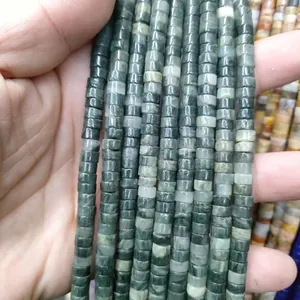 Macro shot of 3x6mm natural green stone spacer beads for DIY jewelry making