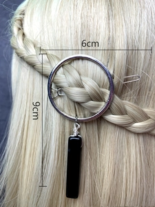 Detail of silver round hair clip with black crystal pendant and 6cm by 9cm dimensions