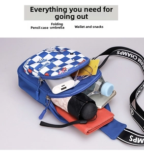 Spacious interior of kids chest bag showing storage for umbrella, phone, and power bank