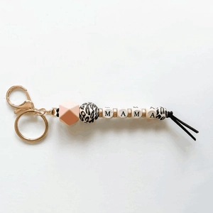 Detailed view of handmade MAMA silicone bead keychain with leopard print and gold clasp
