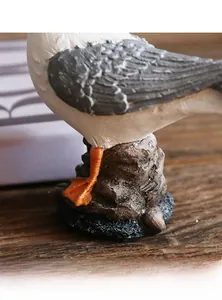 Detail of the stable resin sea bird base with realistic rock texture and orange claws