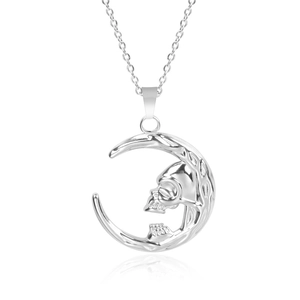 Polished stainless steel moon pendant with embedded skull detail on white background
