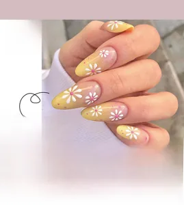 Detail of long stiletto press-on nails with pink floral patterns and gradient finish