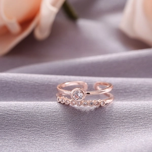 Detailed close-up of rose gold double-layered adjustable ring with cubic zirconia stones