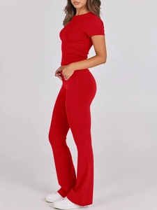 Side view of red short sleeve T-shirt and slim fit flare pants set on model