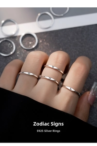Macro shot of S925 sterling silver zodiac rings with engraved constellation symbols