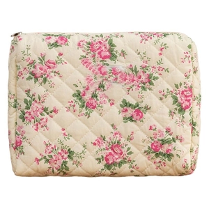 Quilted floral cotton makeup bag with pink flower patterns and metal zipper closure