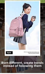 Pink minimalist backpack featuring large main compartment and front zipper pocket detail