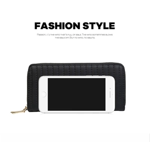 Black PU leather long wallet with vertical stitching next to a phone for size scale