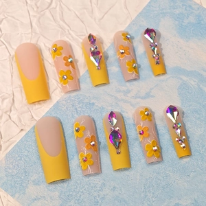 Long coffin yellow French nails with hand-painted flowers and colorful rhinestones