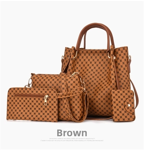 Detail view of a 4-piece set of brown faux leather handbags with geometric print patterns