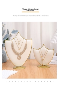 Detailed view of cream-colored velvet jewelry bust display with elegant gold metal trim