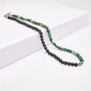Close-up of 6mm black obsidian and green stone beaded necklace with stainless steel OT clasp.