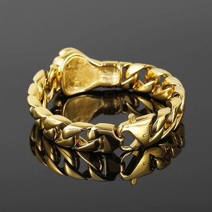 Detail of golden Cuban link bracelet featuring a central boxing glove charm and lobster clasp