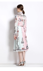 Detail of the pleated hem on a pink and blue asymmetrical floral print midi dress