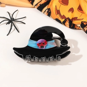 Detail of Halloween hair claw clip featuring black wizard hat with a red skull accent
