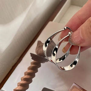 Elegant silver twisted oval hoop earrings for women with minimalist luxury design
