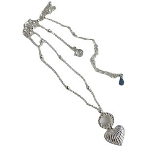 Elegant silver heart pendant necklace with shell texture and beaded chain on white background