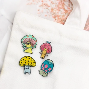 Set of four colorful cute mushroom enamel pins featuring guitar and angel designs on canvas