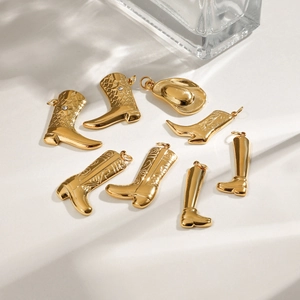Macro shot of gold stainless steel cowboy boot charms and hat pendants with small rhinestones