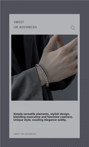 Detail of silver double-layer keel chain bracelet on male model wrist in grey suit