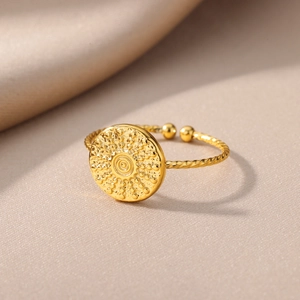 Macro detail of 18k gold plated stainless steel ring with twisted band and relief design