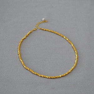 Minimalist gold plated brass necklace with irregular faceted beads and pearl detail