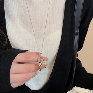 Detailed view of 18k gold plated interlocking triple ring pendant on a delicate chain